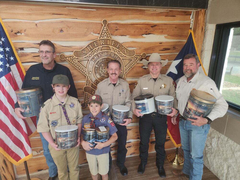 Command staff posing with their cans of popcorn