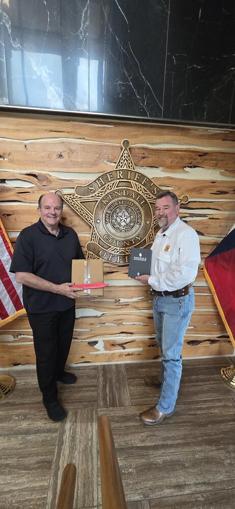 Sheriff and Mike holding a Bible
