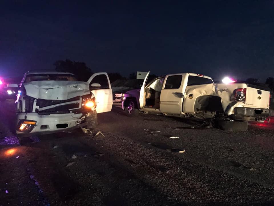 Wreckage of two white trucks 