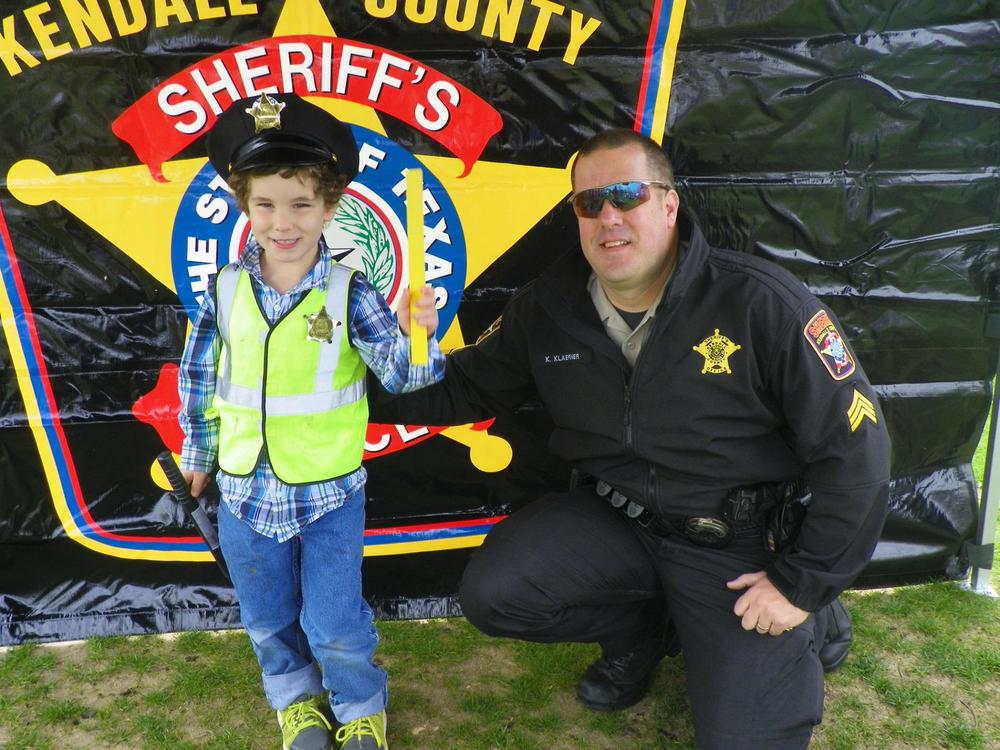 Officer and Small Boy dressed as a policeman 