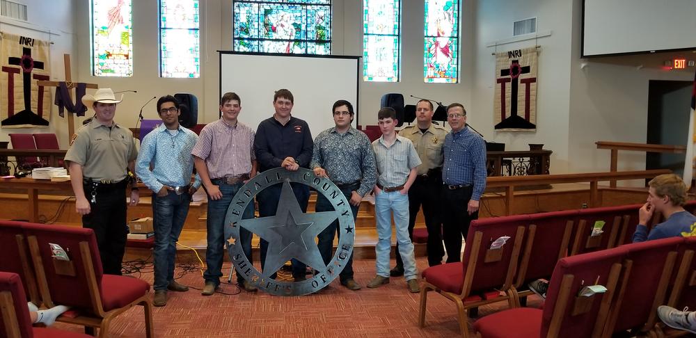 High School Ag Mechanics class with new metal sheriff sign 