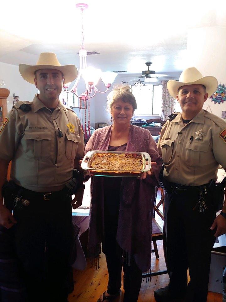 Lady in the community delivering cake to the sheriff's office 